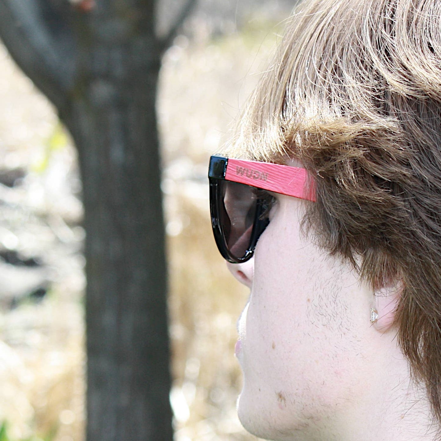 bluntslide red sunglasses with a pink frame outdoors