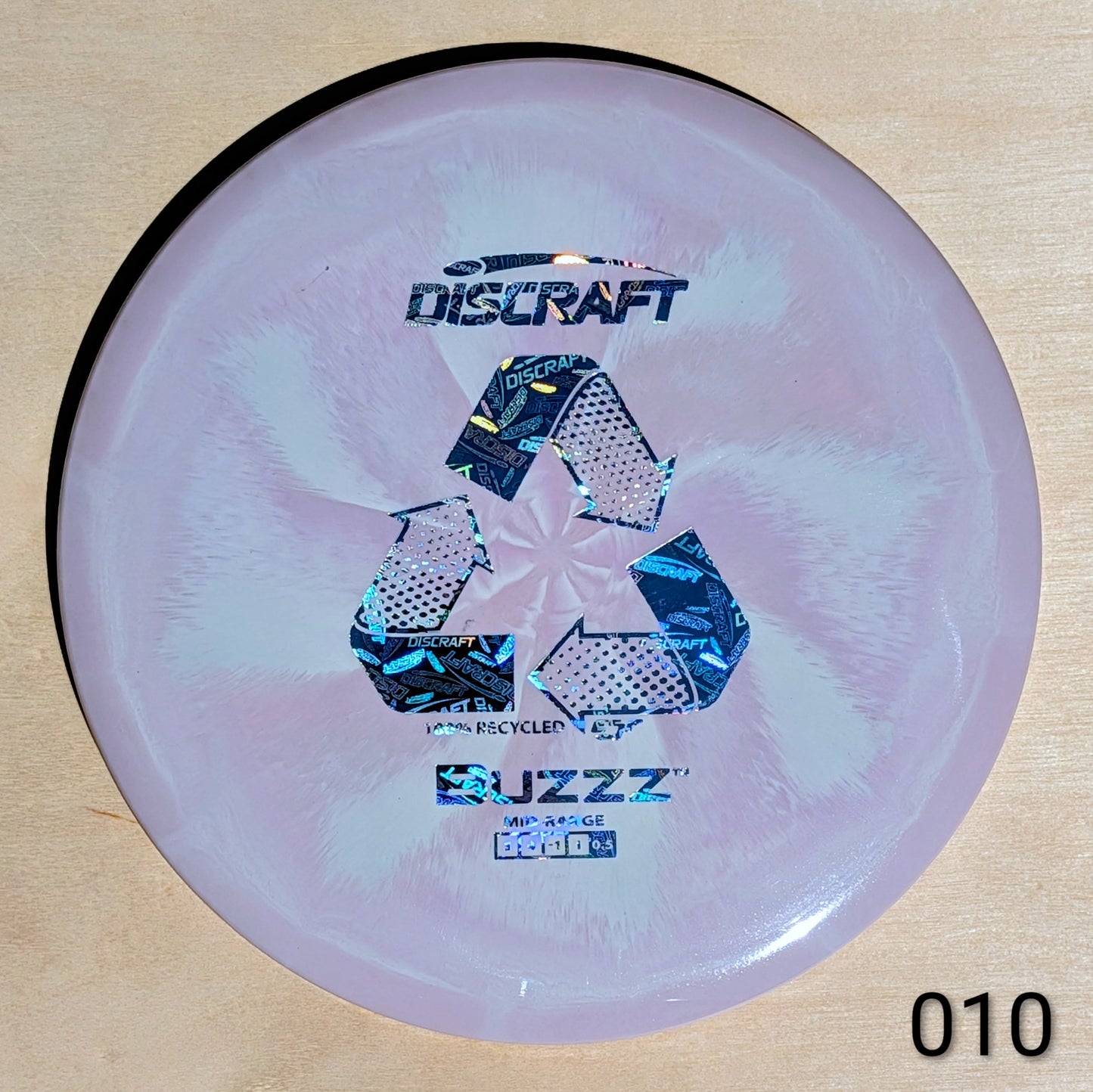 Discraft Buzzz disc golf disc on a wooden surface