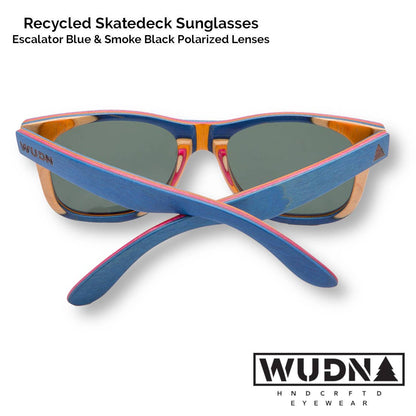 Escalator blue Recycled skatedeck sunglasses with blue and orange frame and green lenses on a white background, featuring WUDN logo.