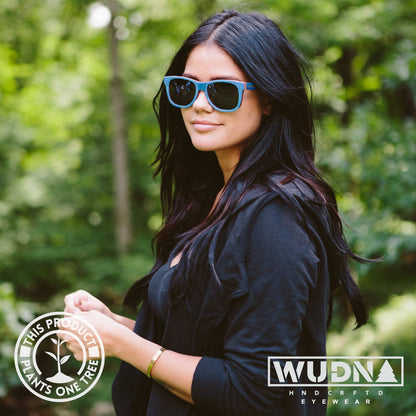 Escalator blue Recycled sunglasses with a forest background, featuring WUDN eyewear branding.