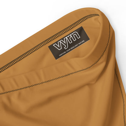 GOLDEN CLAY Close-up detail showing the secure anti-slip lining and the VYRN logo on Tangled Roots Bikini Bottom