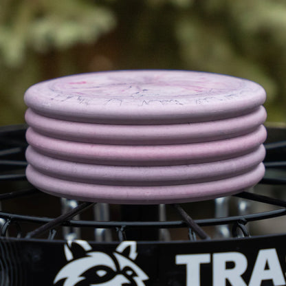 Geode Swirl - Trash Panda Inner Core recycled premium putter disc 5 stack on a disc golf basket. 