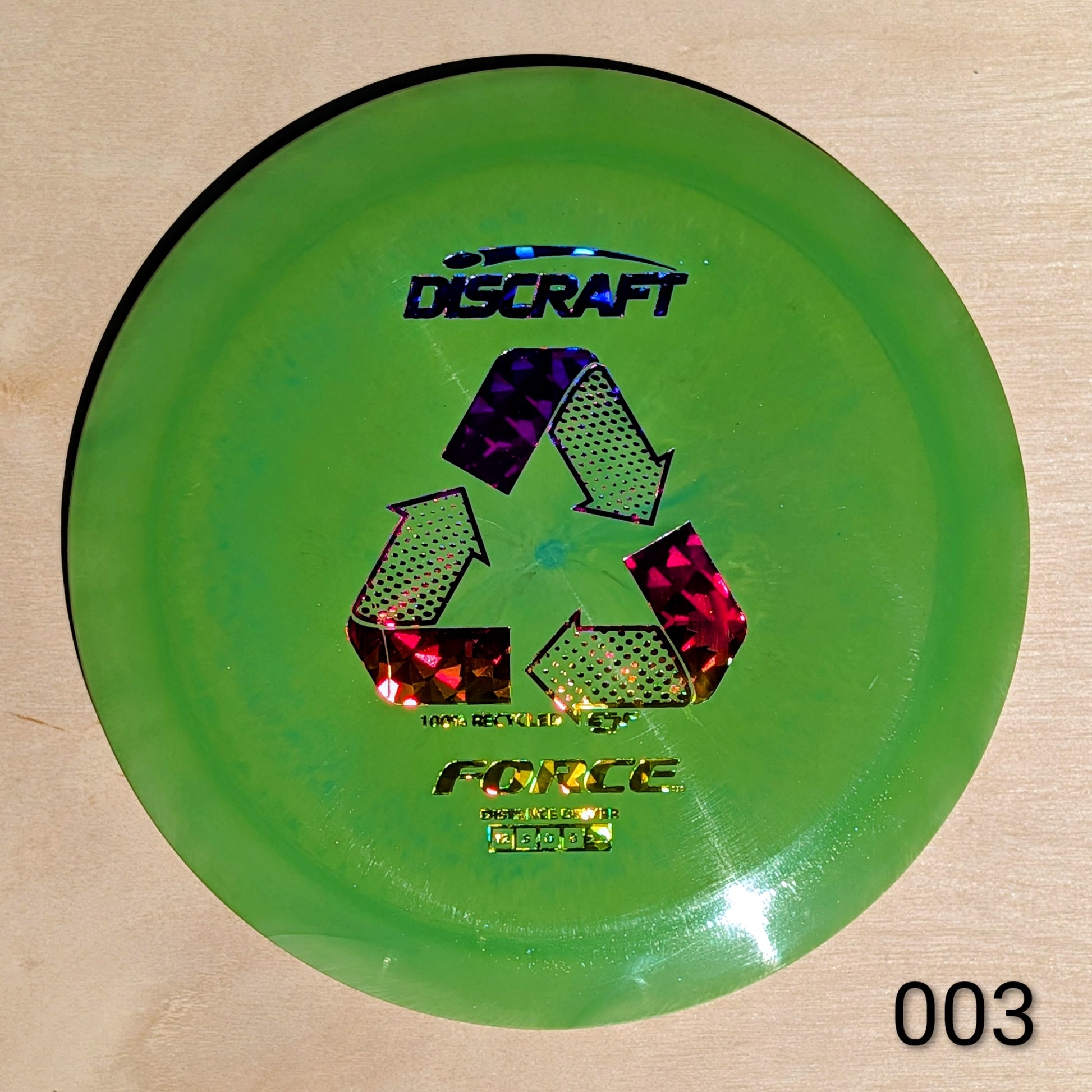 Green Discraft disc on a beige background