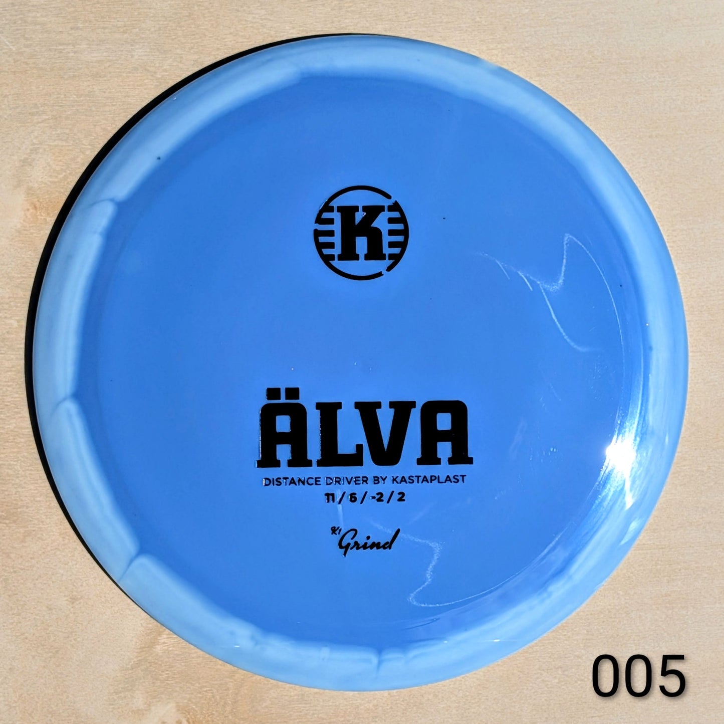 Blue disc with 'K' logo and text on a beige background