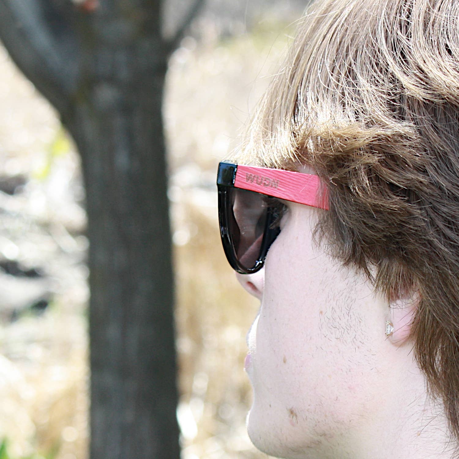 bluntslide red sunglasses with a pink frame outdoors