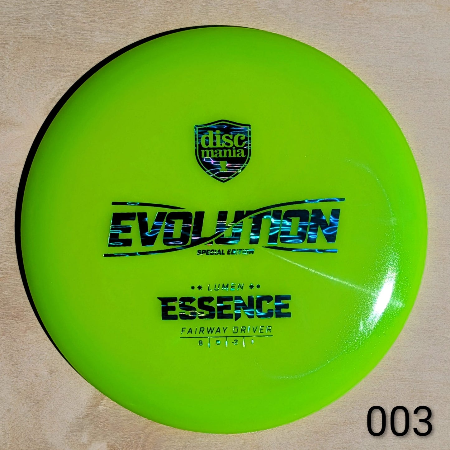 Green disc with 'Discmania' and 'Evolution' branding on a beige background
