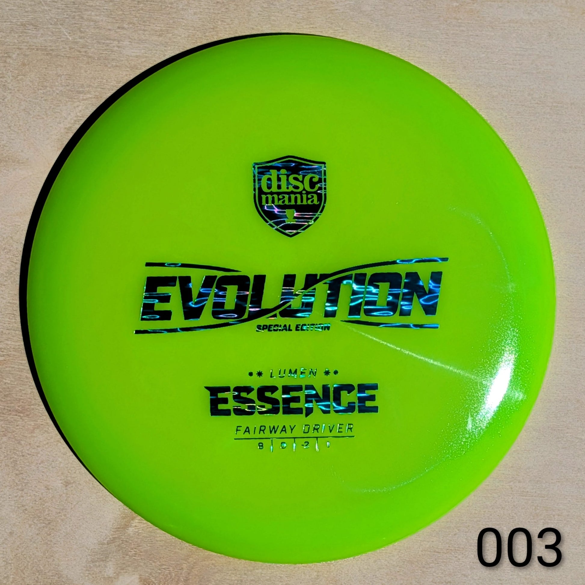 Green disc with 'Discmania' and 'Evolution' branding on a beige background