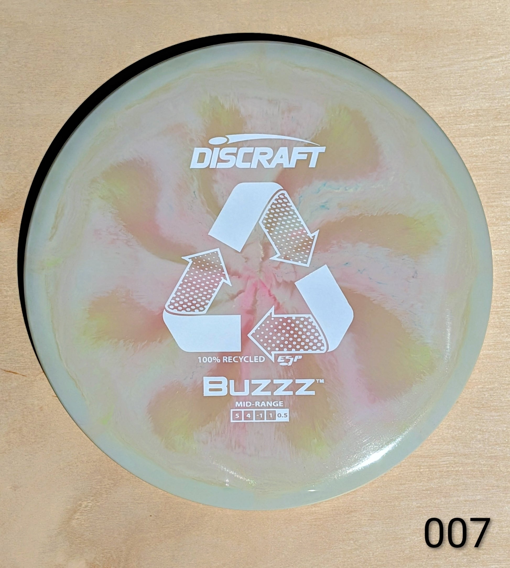 Discraft Buzzz disc golf disc on a wooden surface
