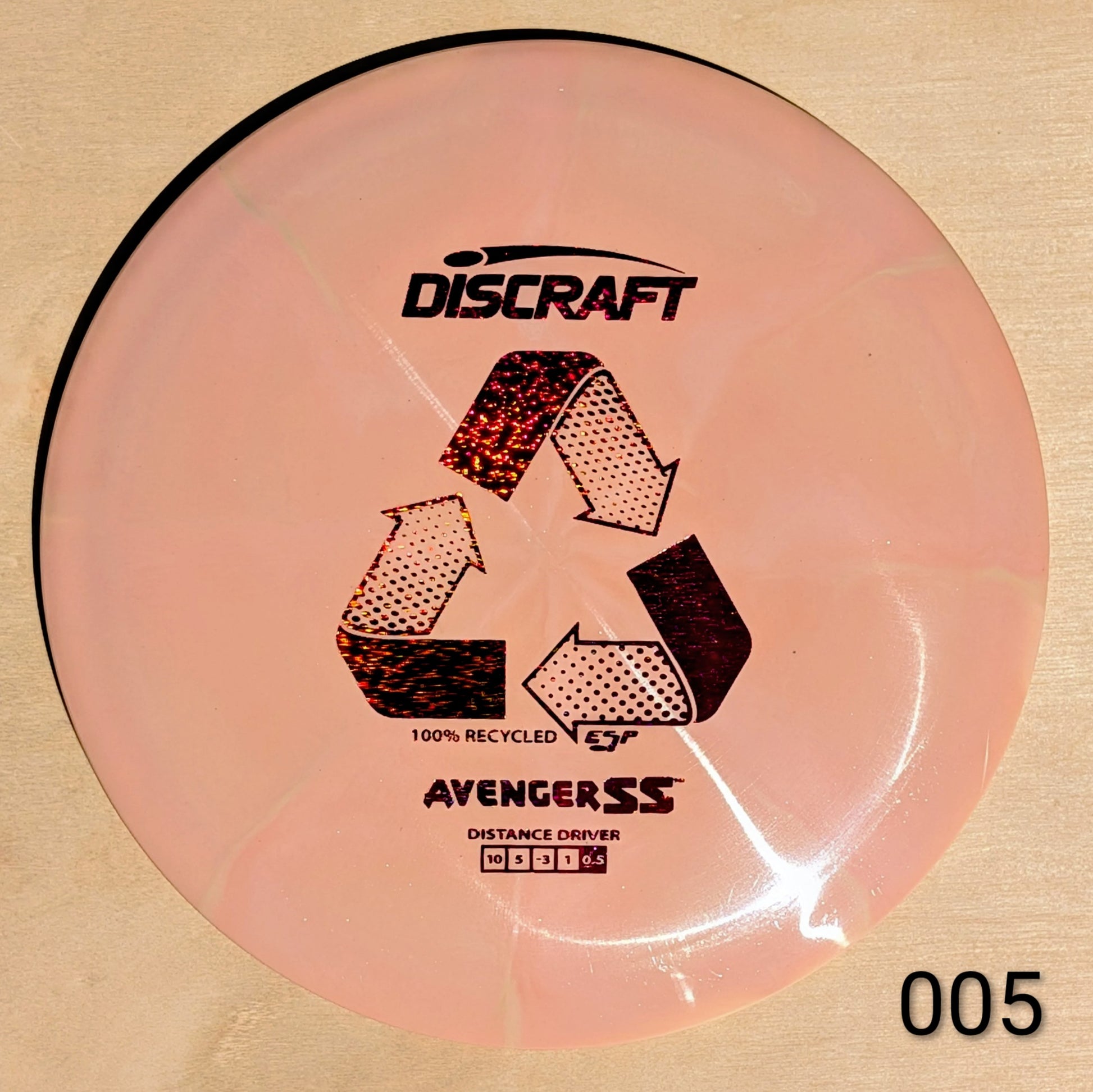 Discraft Avenger SS disc golf disc on a beige background