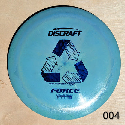 Blue Discraft Force disc golf disc on a wooden surface
