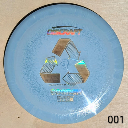 Blue disc with Discraft logo and recycling symbol on a beige background