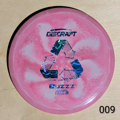 Pink disc with Discraft branding on a wooden surface