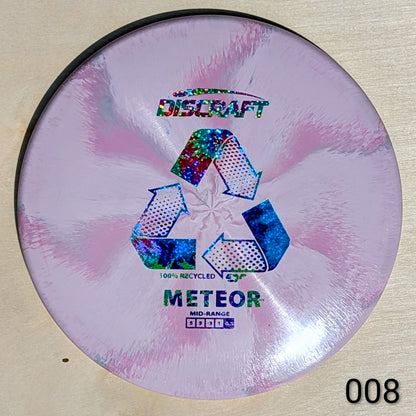 Discraft Meteor disc golf disc on a beige background
