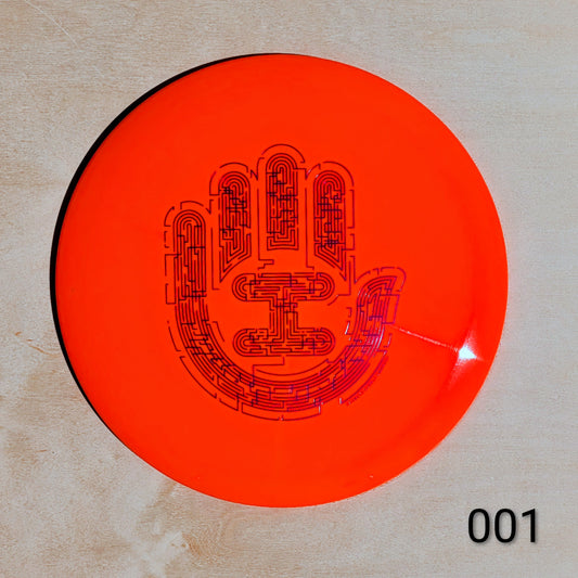 Orange disc with black hand design on a beige background