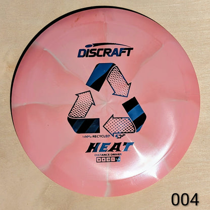 Pink Discraft Heat disc golf disc on a beige background
