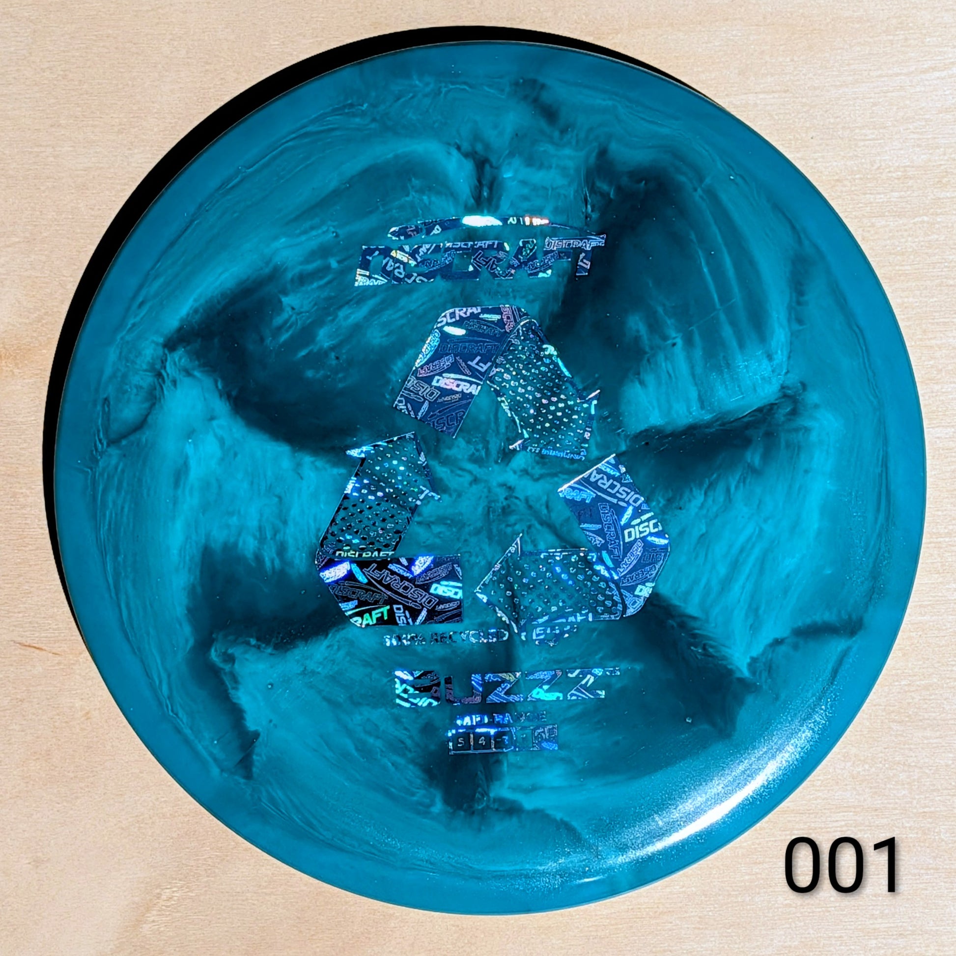 Blue plastic item with reflective surface on a beige background