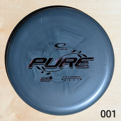 Blue disc golf disc with 'Latitude 64' and 'Pure' branding on a beige background