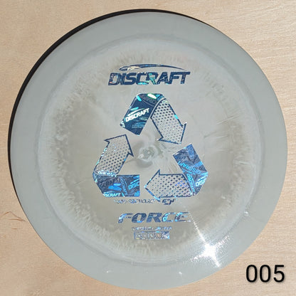 Discraft Force disc golf disc on a beige background
