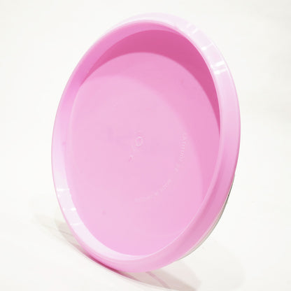 Pink plastic disc golf disc on a white background