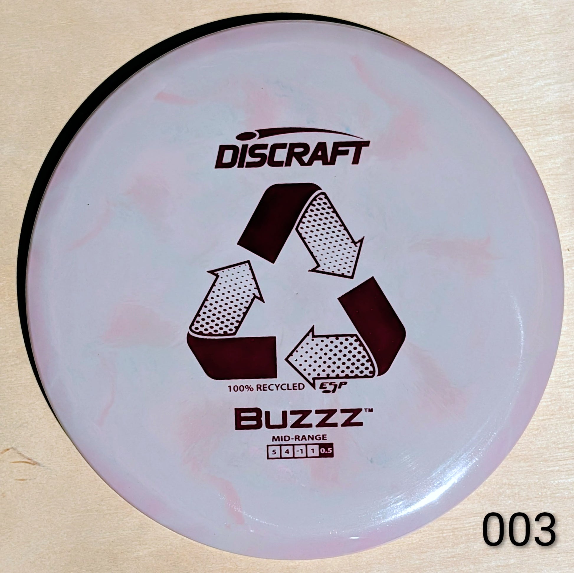 Discraft Buzzz disc golf disc on a wooden surface