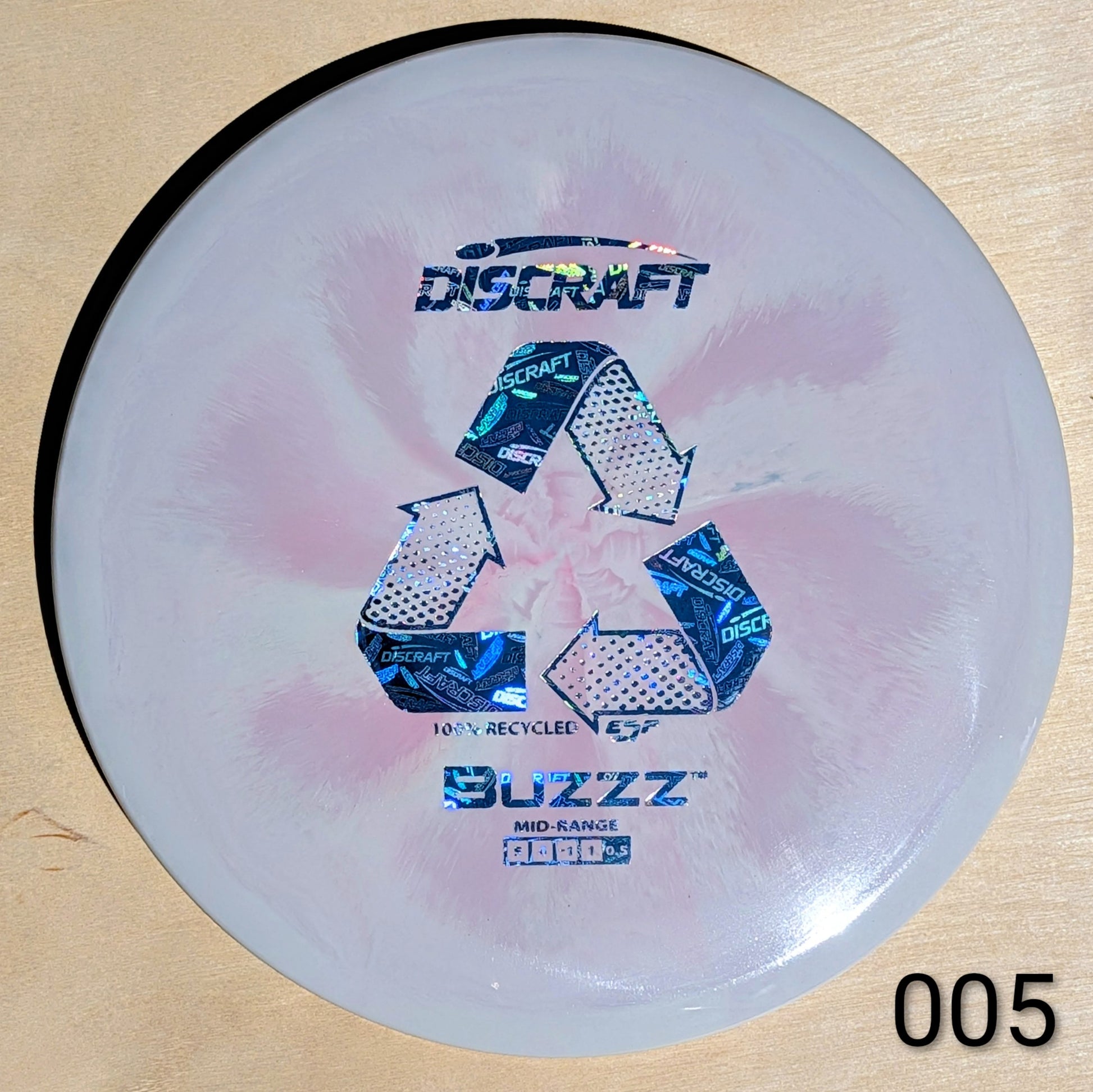 Discraft Buzzz disc golf disc on a wooden surface