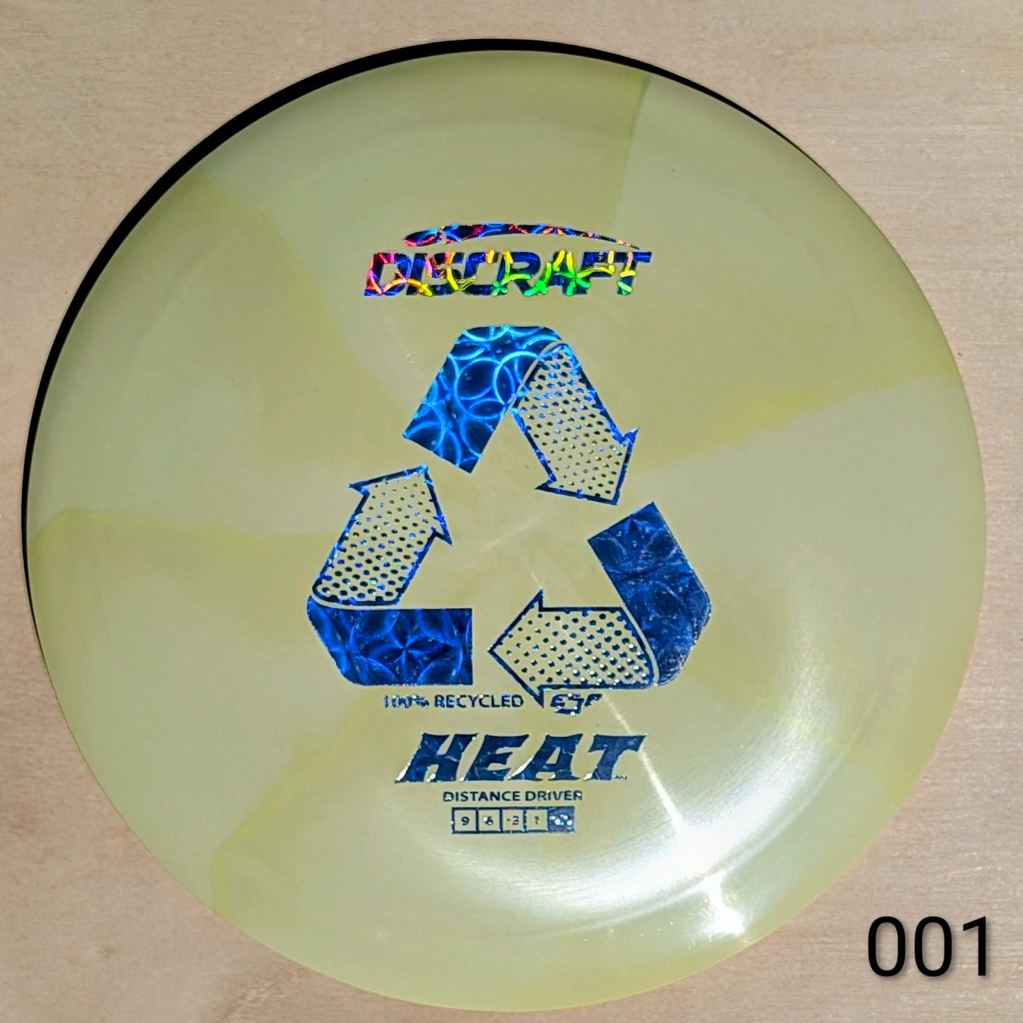 Disc golf disc with branding and text on a beige background
