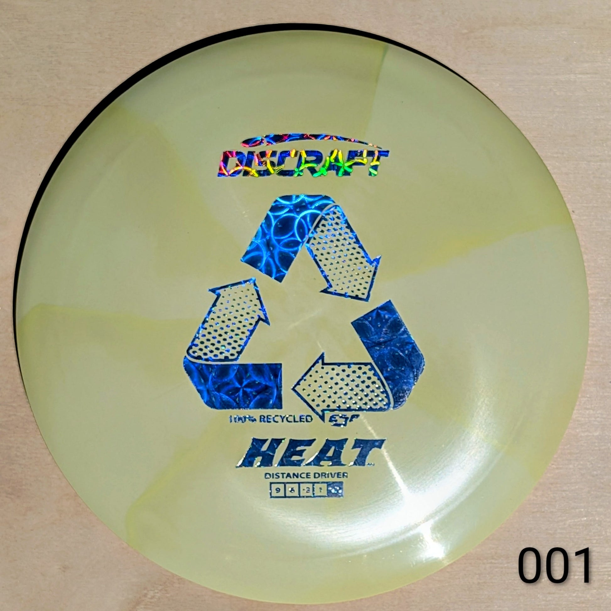 Disc golf disc with branding and text on a beige background