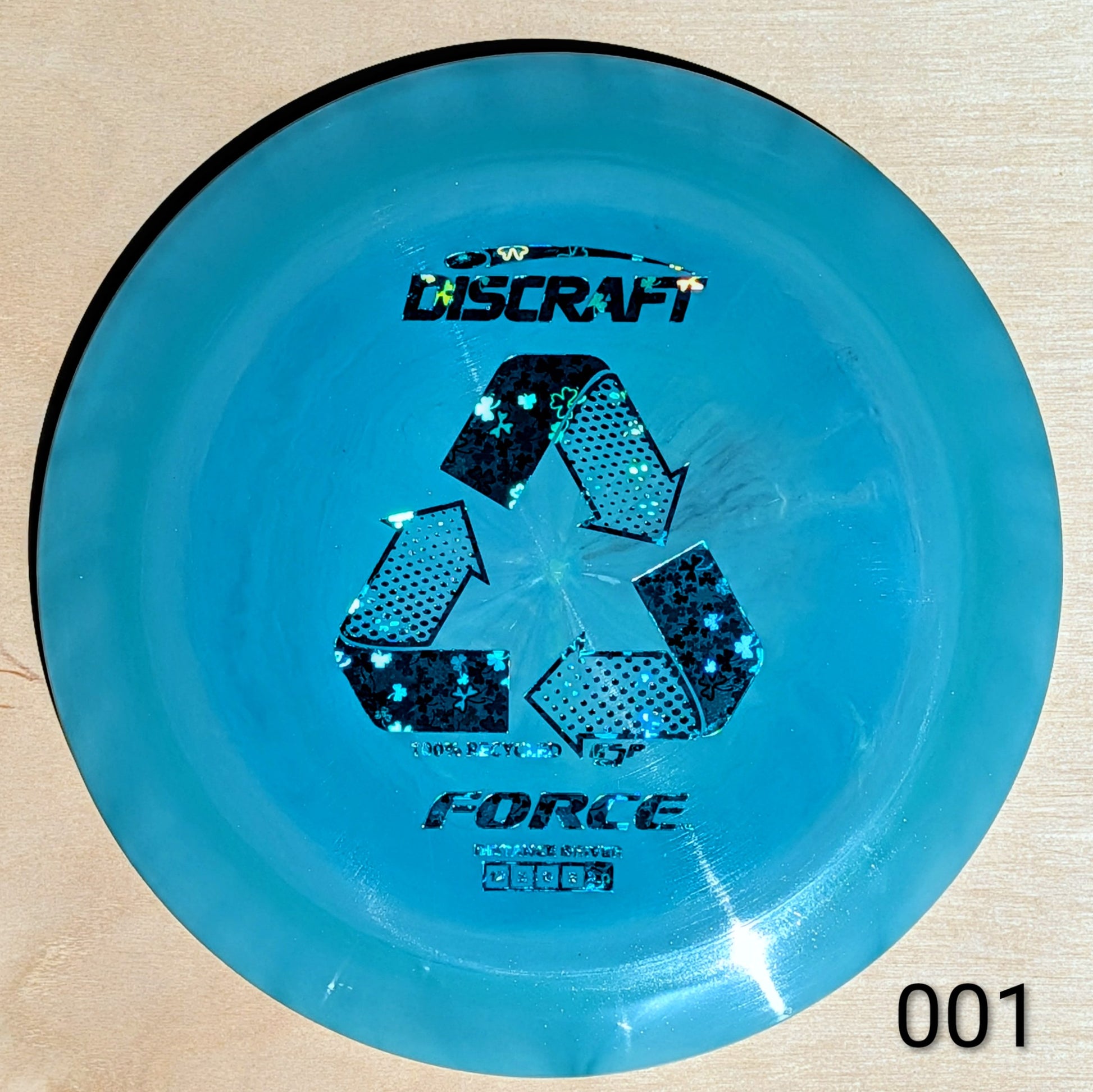 Blue Discraft Force disc on a beige background
