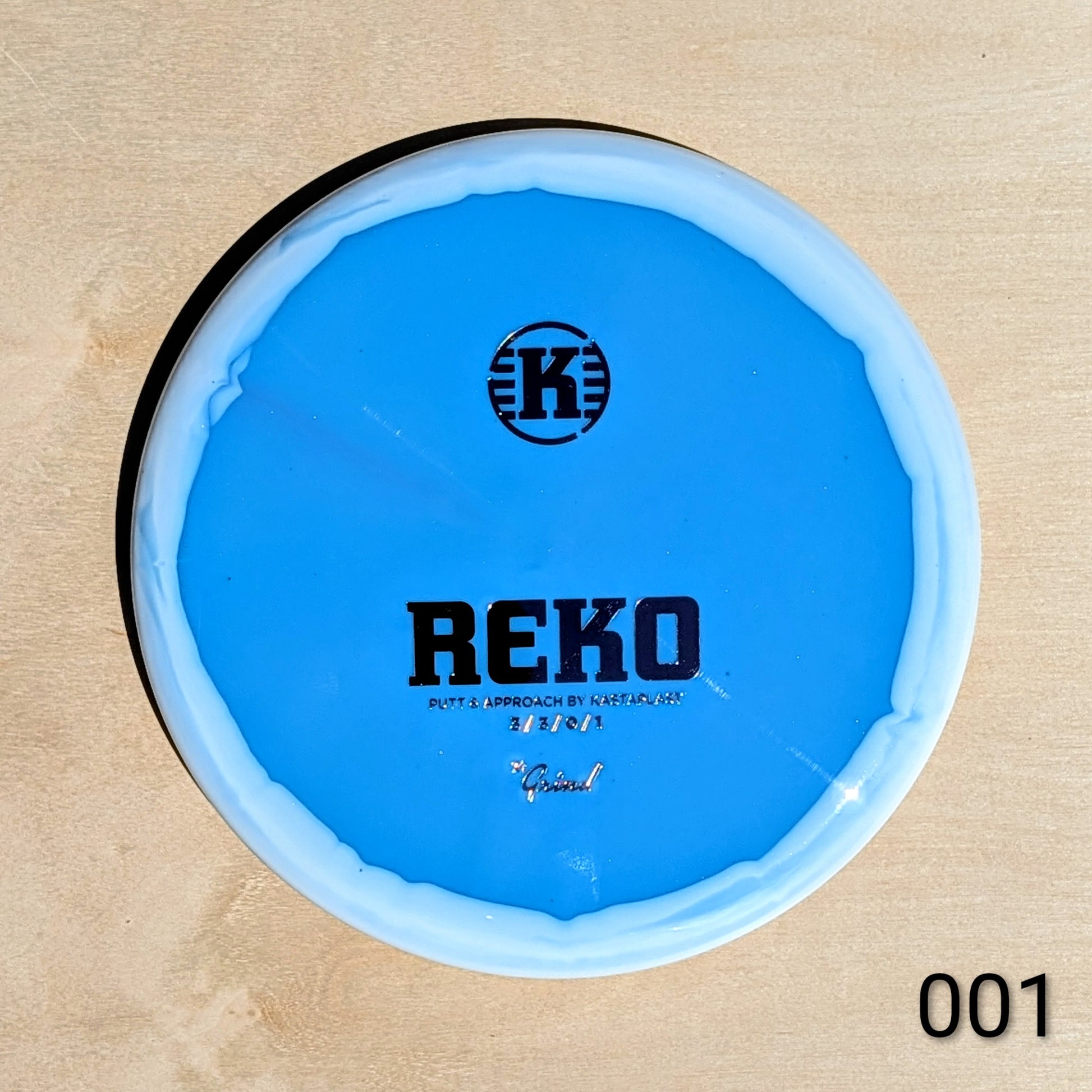 Blue disc with 'REKO' and 'K' logo on a beige background