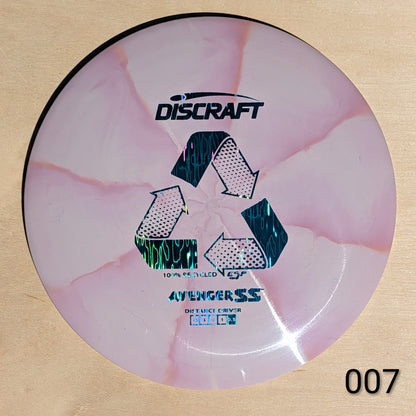 Discraft disc golf disc with pink and white design on a beige background