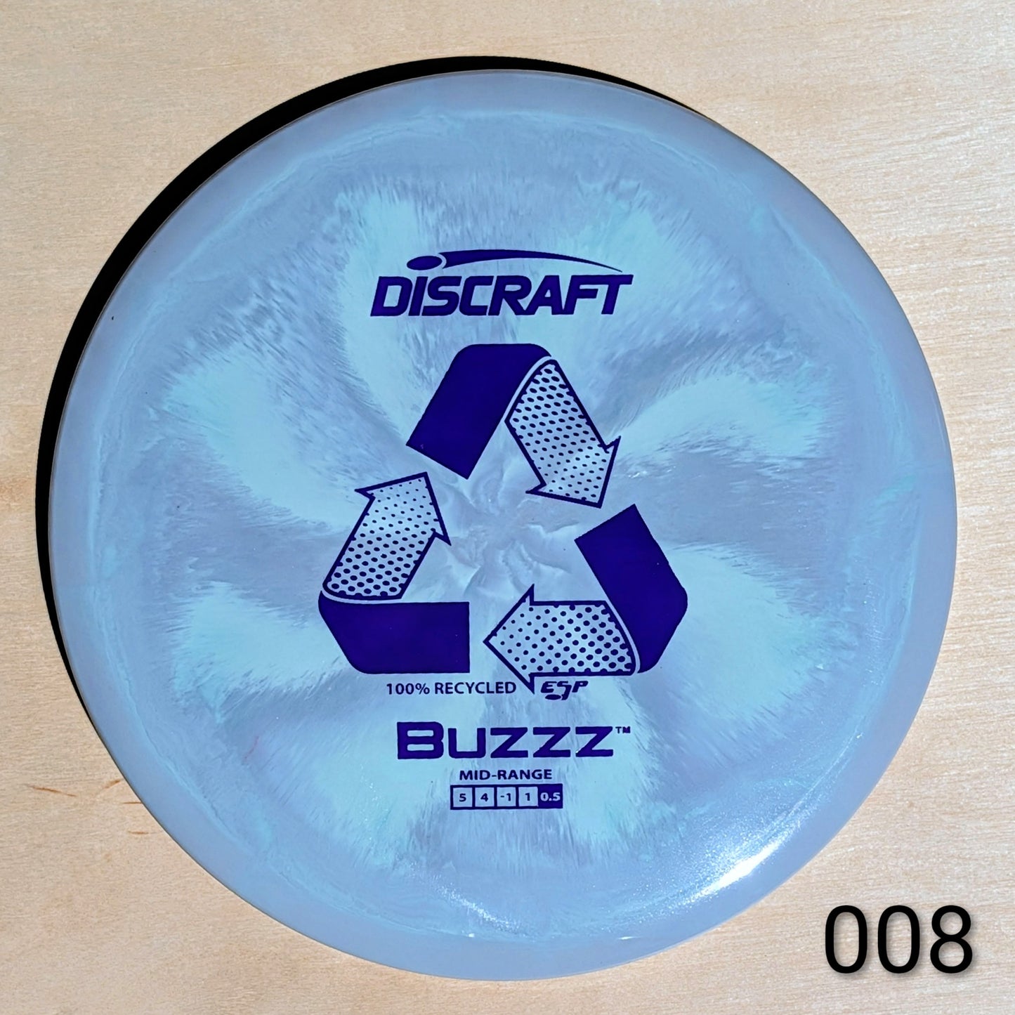 Discraft Buzzz disc golf disc on a wooden surface