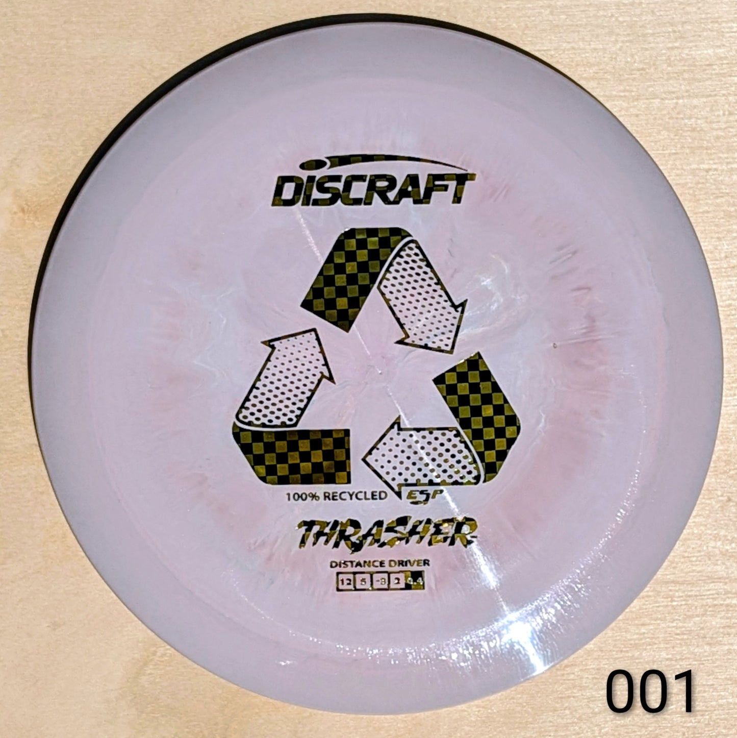 Discraft Thrasher disc golf disc on a beige background