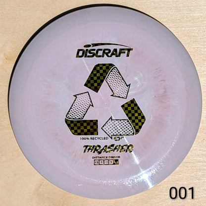 Discraft Thrasher disc golf disc on a beige background