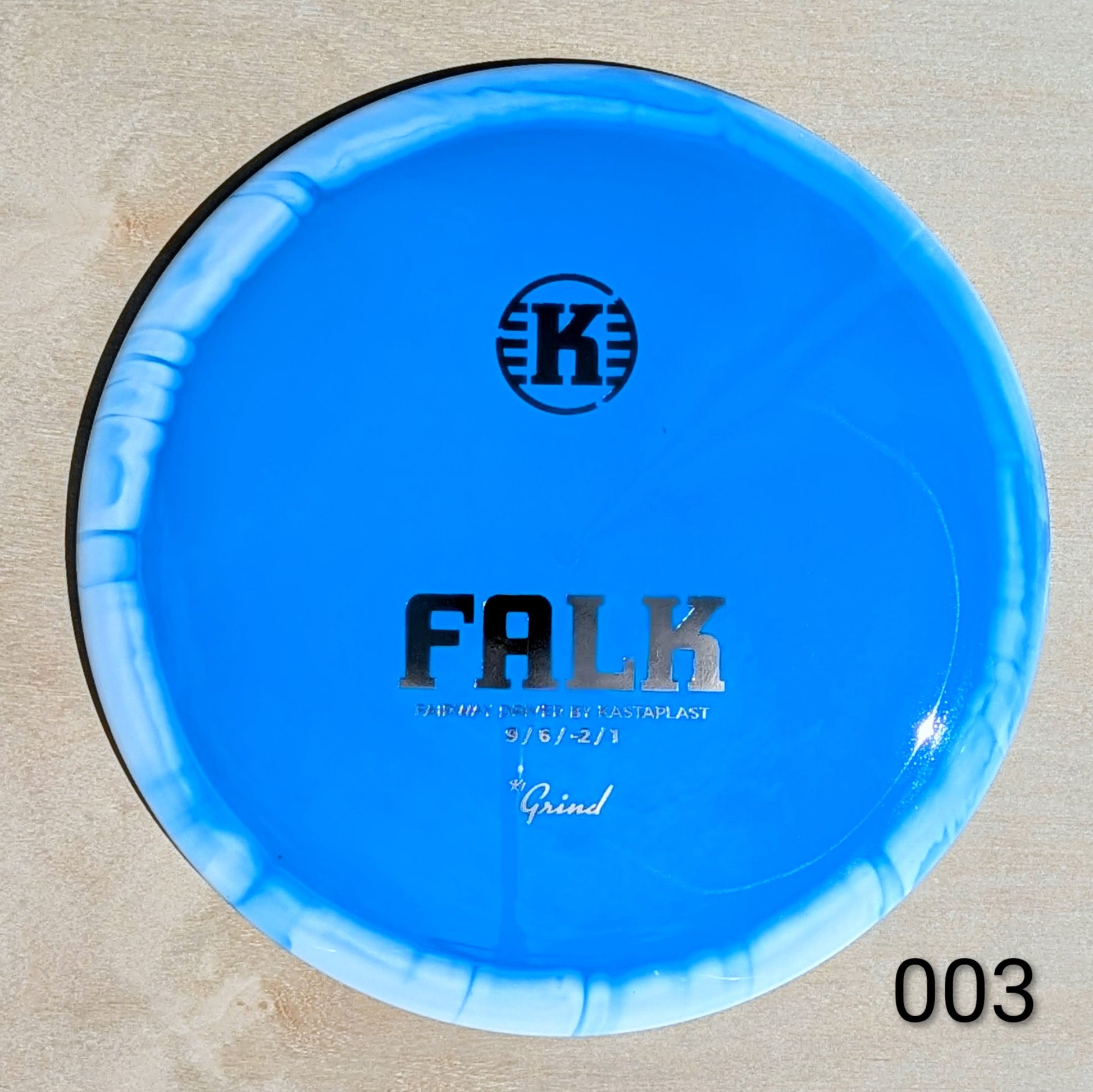 Blue disc with 'K' logo and text on a beige background