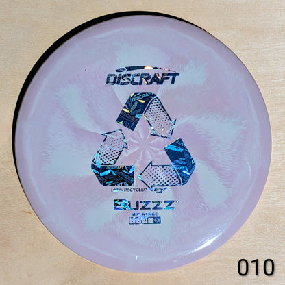 Discraft Buzzz disc golf disc on a wooden surface