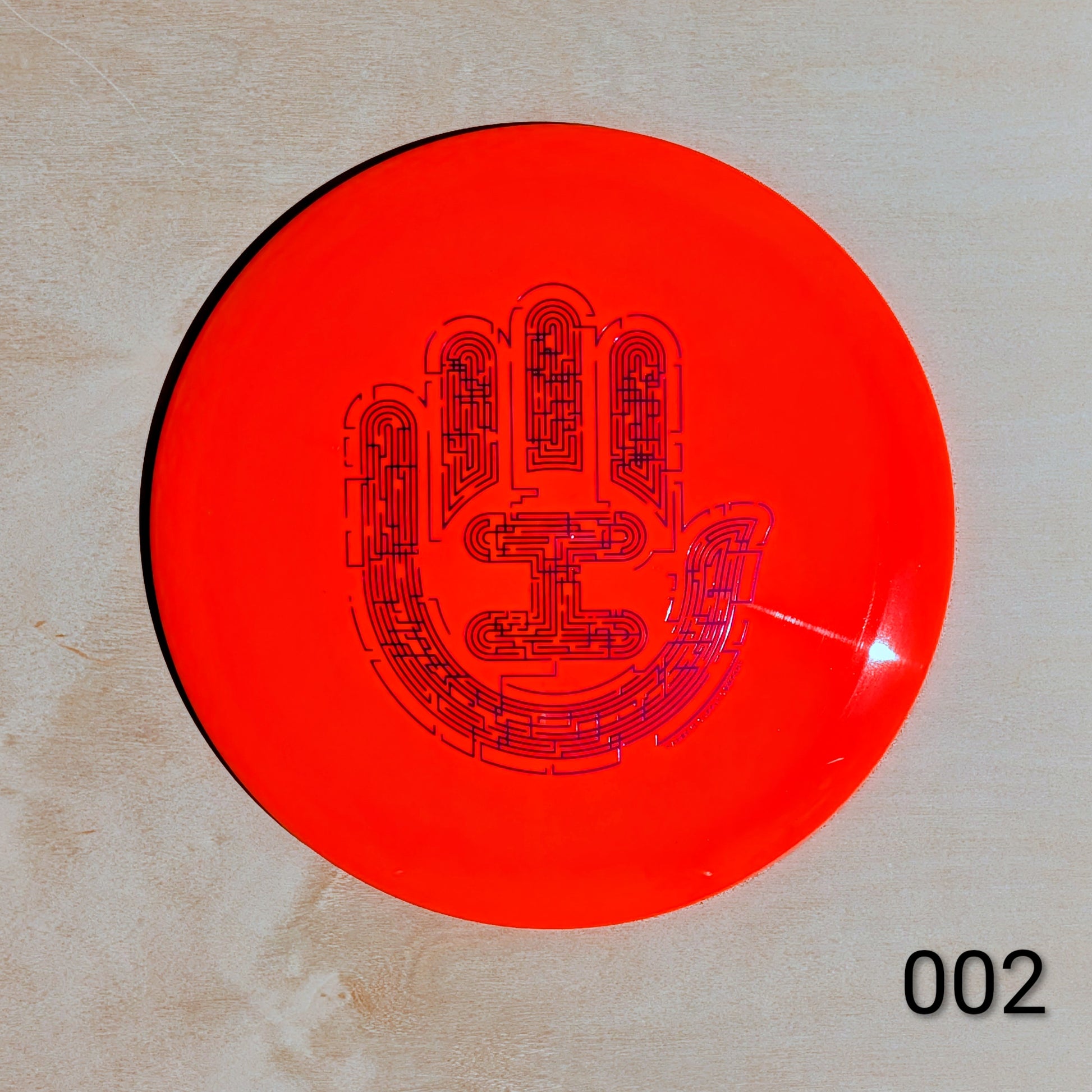Red disc with black text and design on a beige background