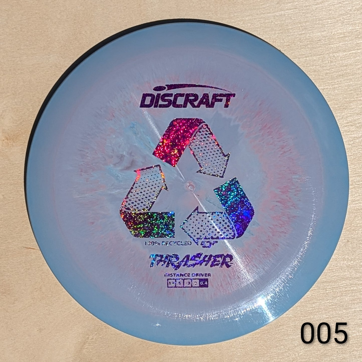 Discraft Thrasher disc golf disc on a beige background