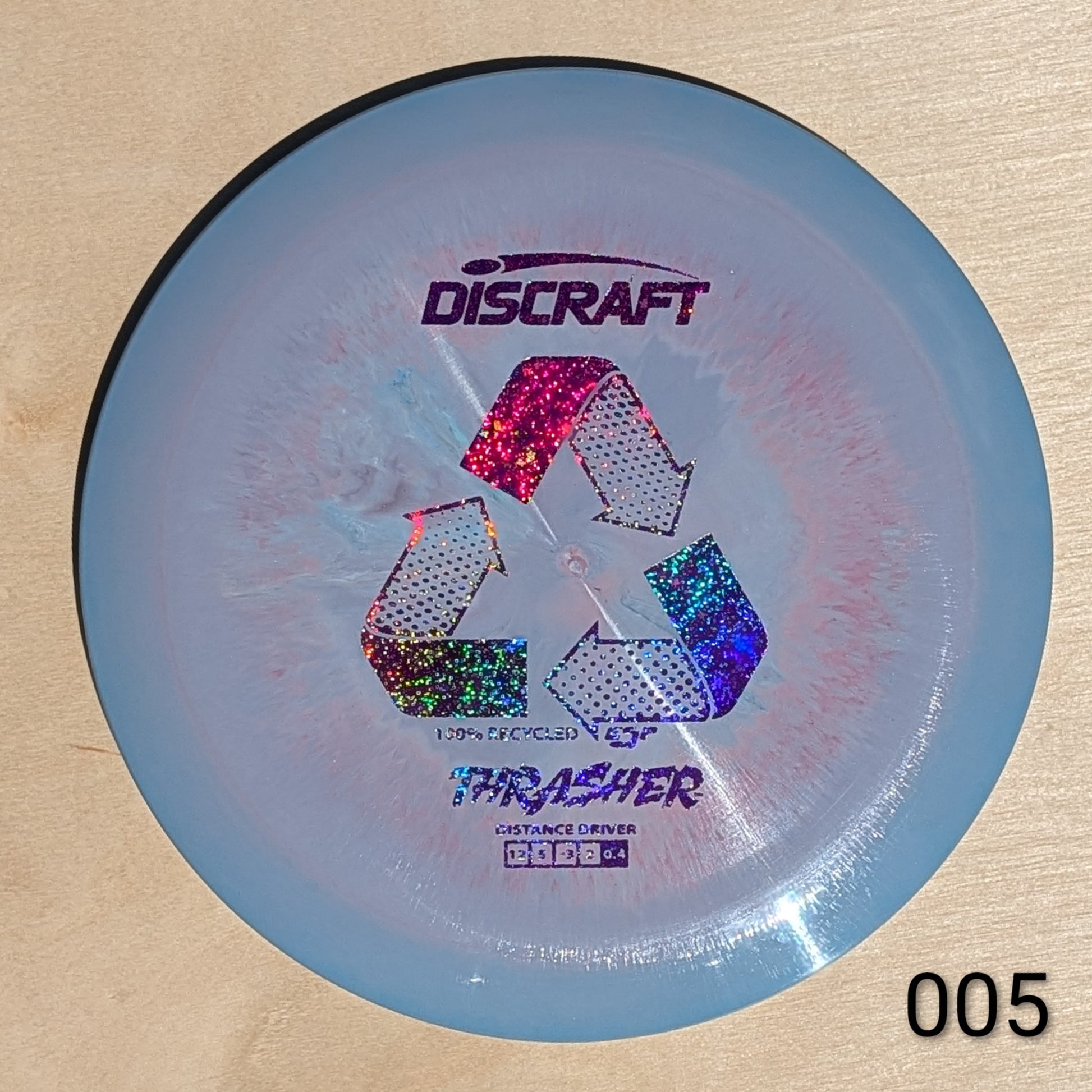 Discraft Thrasher disc golf disc on a beige background