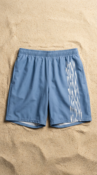 Glacial blue shorts with a white logo on a sandy background