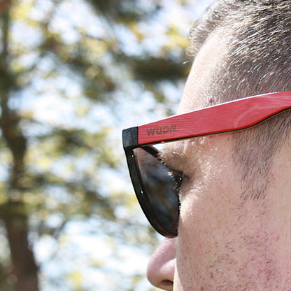 bluntslide red sunglasses with 'WUDN' branding outdoors