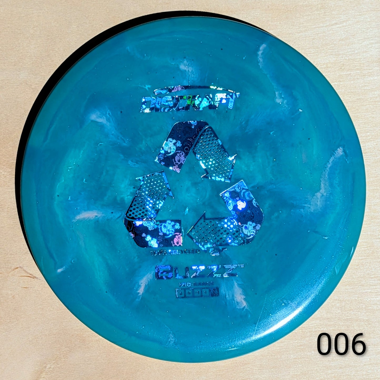 Blue disc with branding on a beige background