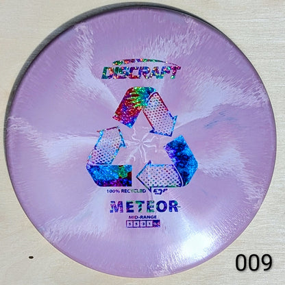 Discraft Meteor disc golf disc with recycling symbol on a light background
