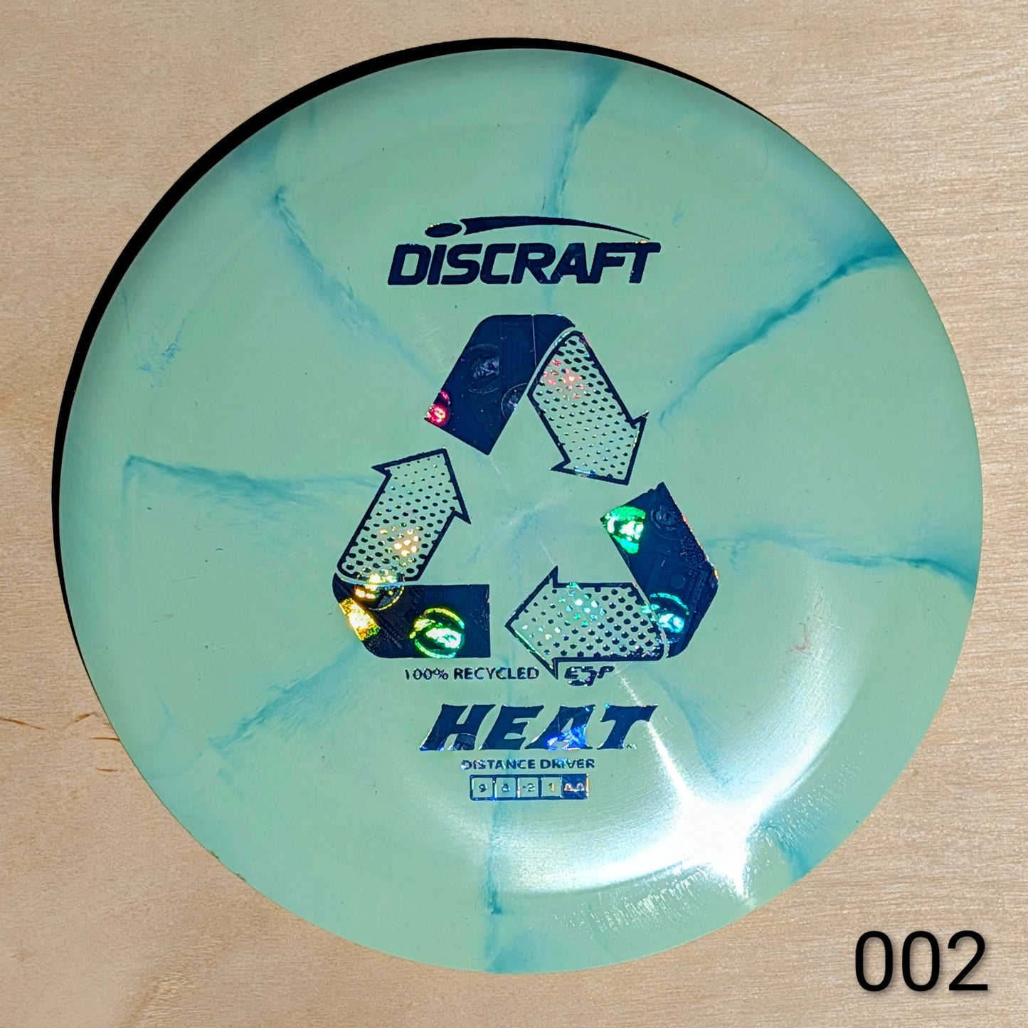 Discraft Heat disc golf disc on a beige background
