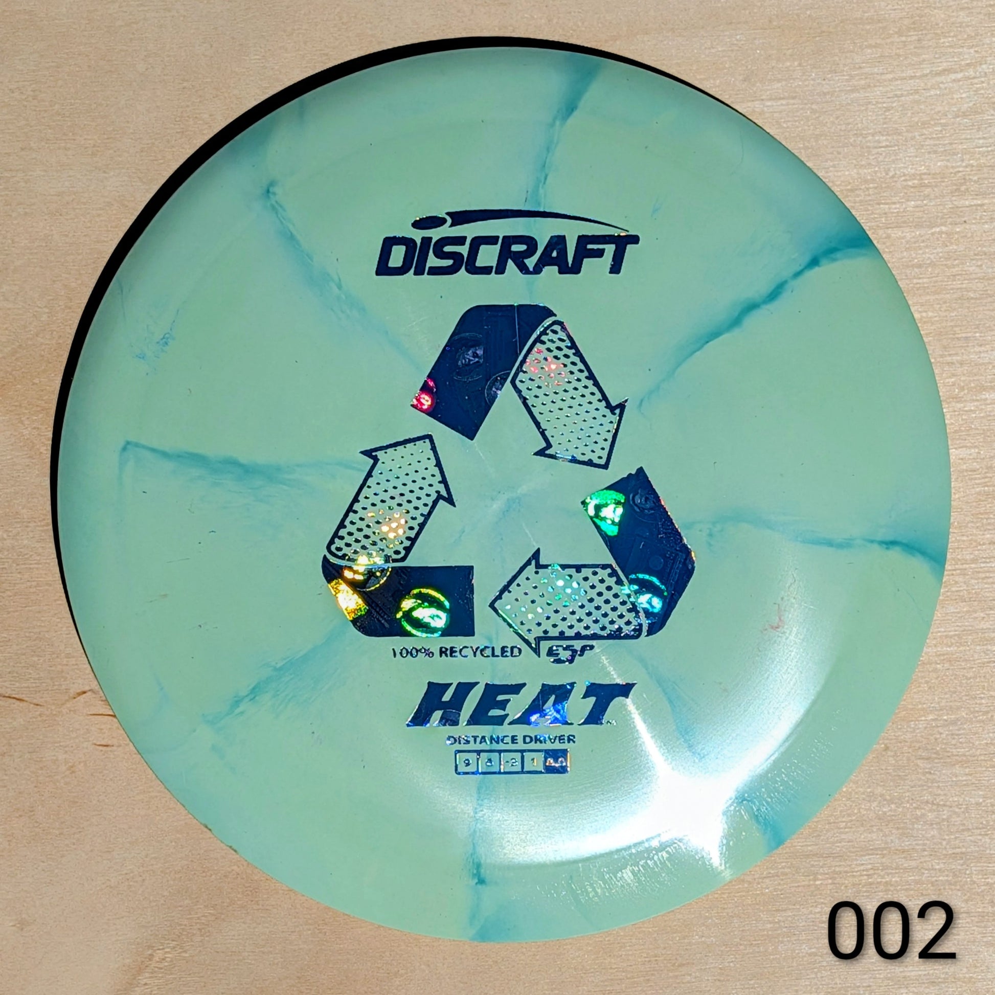 Discraft Heat disc golf disc on a beige background