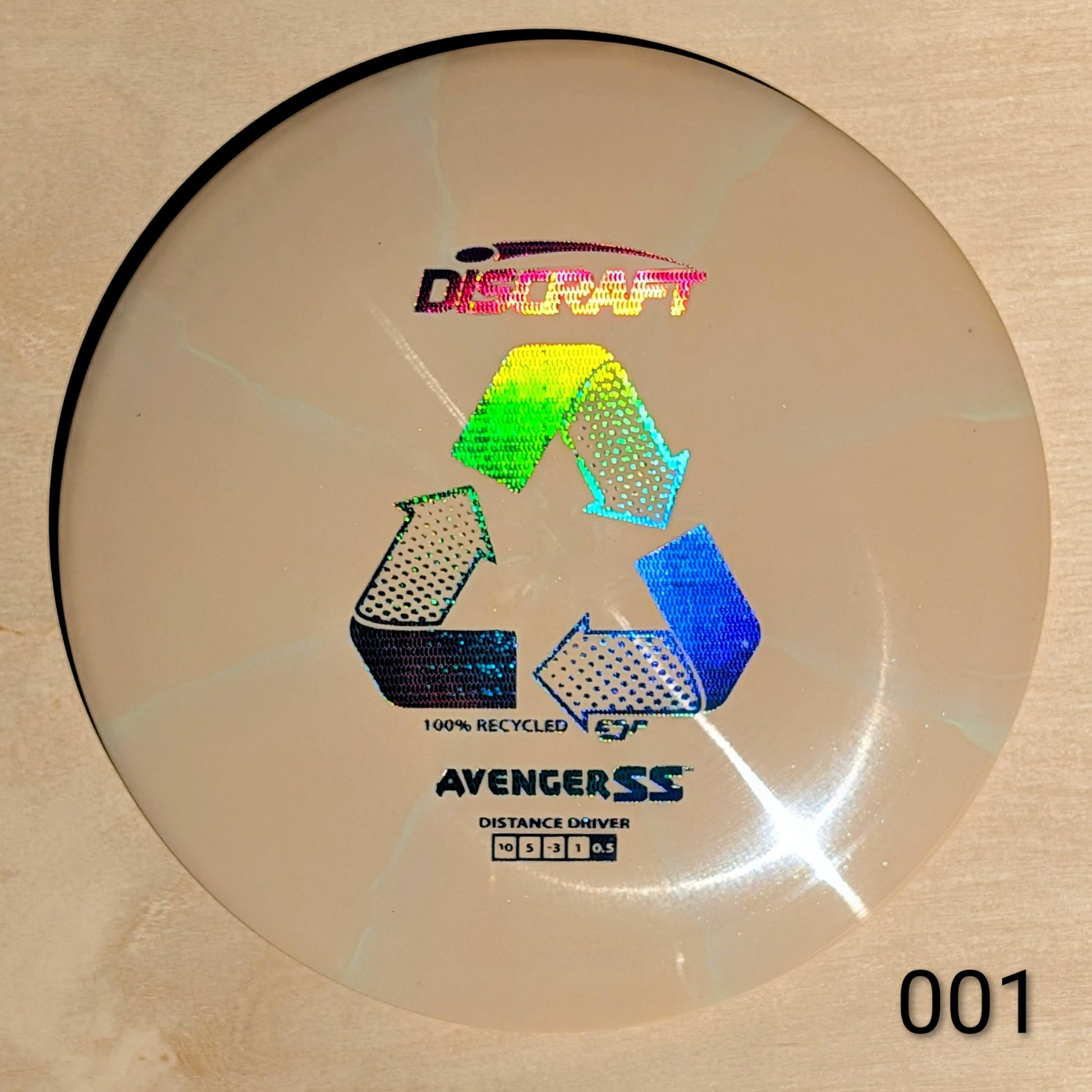 Discraft Avenger SS disc golf disc on a beige background