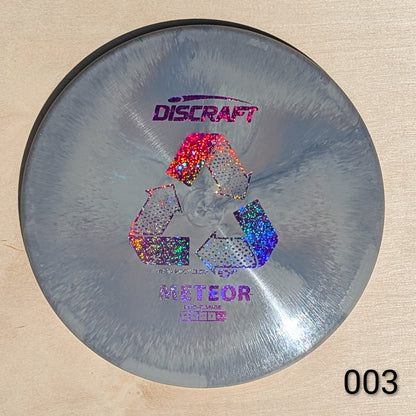 Discraft Meteor disc golf disc on a wooden surface
