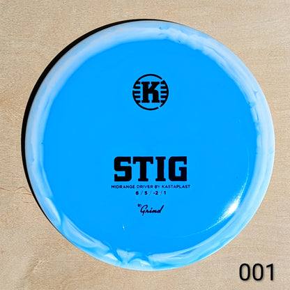 Blue disc golf disc with 'K' logo and text on a beige background