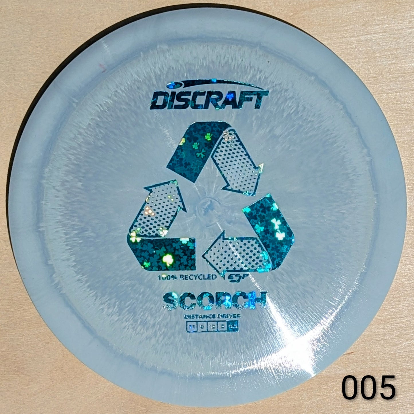 Discraft Scorch disc golf disc on a beige background