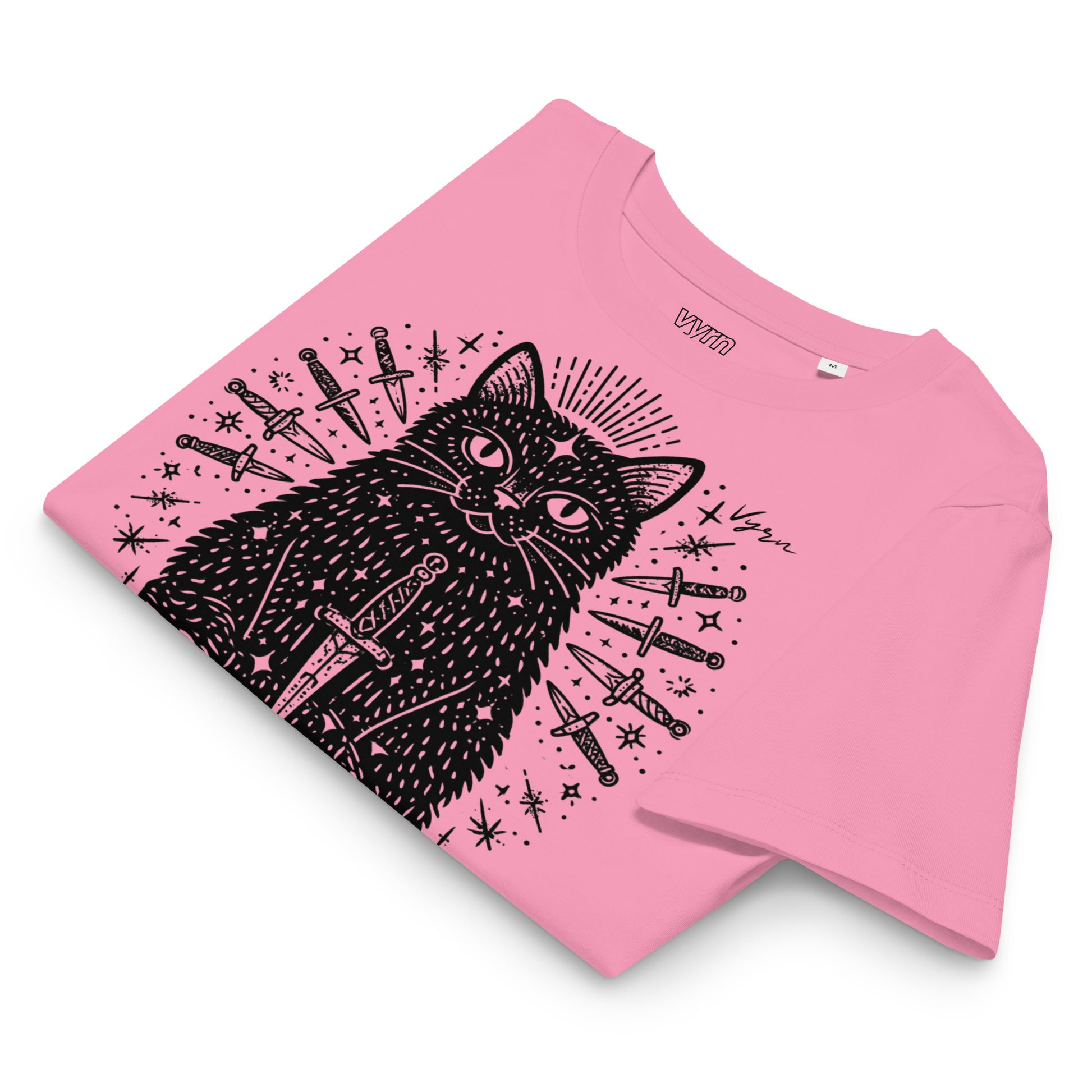 bubble pink short-sleeve T-shirt laid flat on a white background, featuring a black line-art graphic of a cat surrounded by knives and stars. The brand name 'UOMO' is printed inside the collar.