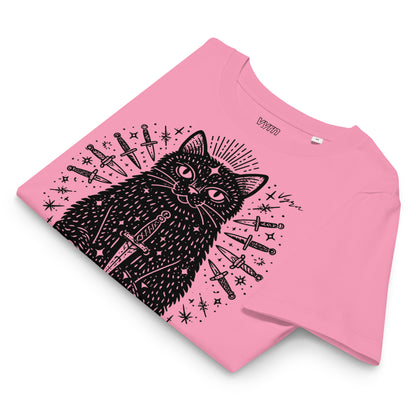 bubble pink short-sleeve T-shirt laid flat on a white background, featuring a black line-art graphic of a cat surrounded by knives and stars. The brand name 'UOMO' is printed inside the collar.